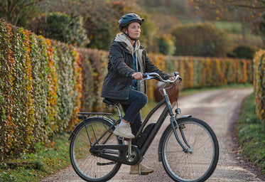 Rider on a HITWAY step-through electric bike on a British country lane