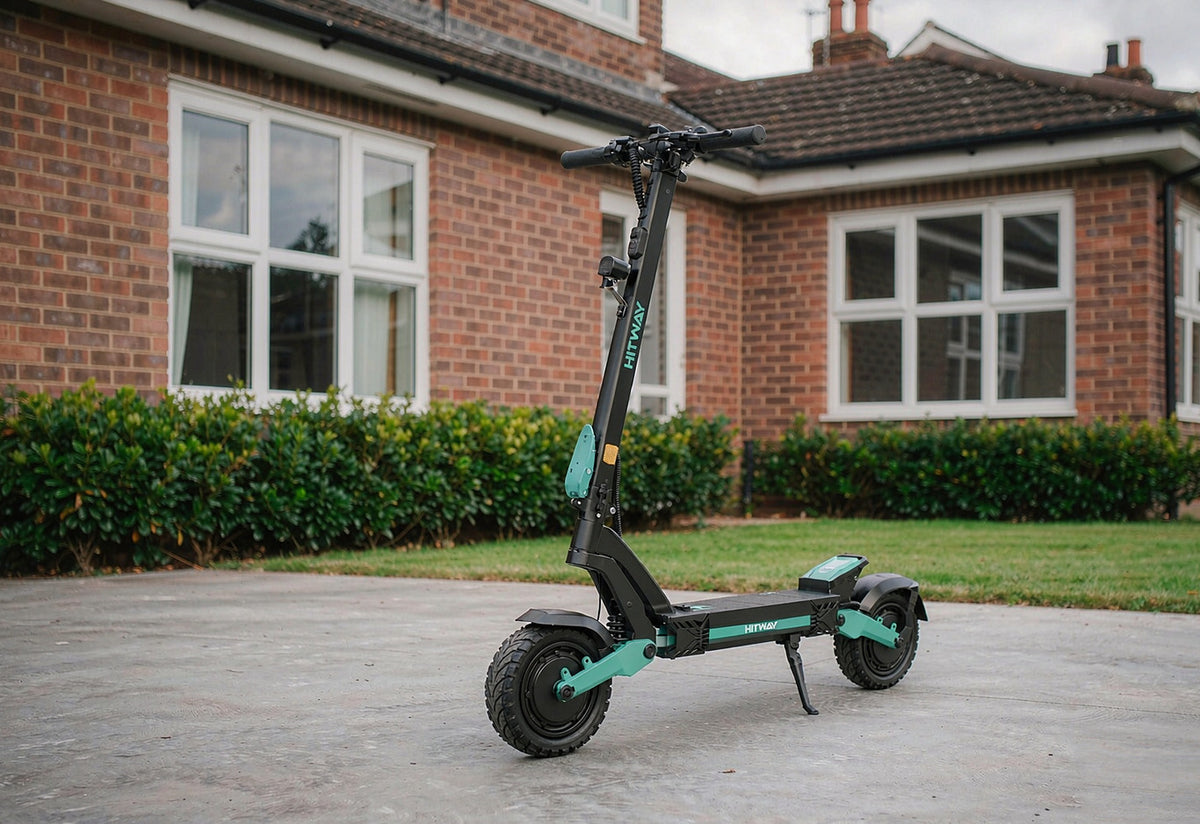 HITWAY H11 electric scooter with mint-green accents on the driveway of an English brick house — UK e-scooters