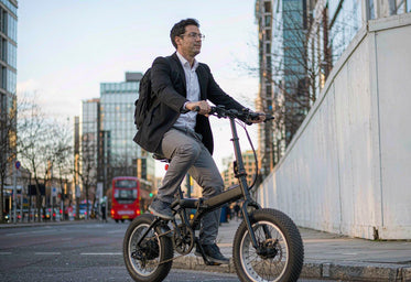 Commuter riding a HITWAY folding fat-tyre electric bike in a UK city