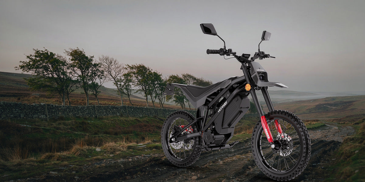 HT500 electric dirt bike on a British moorland green lane — desktop banner